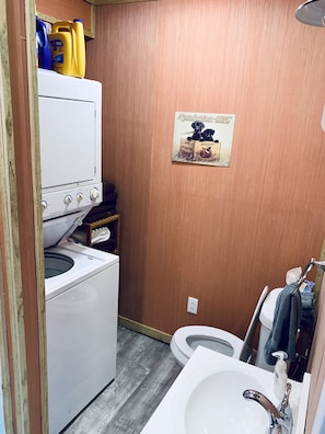 Stackable washer and dryer in bathroom. 