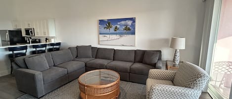 Large living room with plenty of comfortable seating with beautiful ocean view