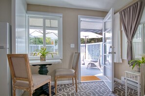 Natural light and fresh air, from private patio. Dining for 2 indoors. 