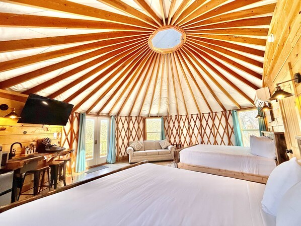 Yurt 3 at East Zion Resort with 2 king beds, queen sofa bed, flat screen tv, Wifi, fridge, keurig coffee maker, kitchenware, private bathroom, heating and air conditioning.