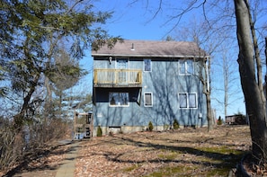 A cozy home tucked away in the woods, on an island, with water front views.