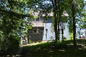 A cozy home tucked away in the woods, on an island, with water front views.