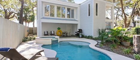 Freeform shaped pool in front of the home