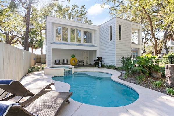 Freeform shaped pool in front of the home