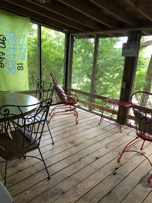 The porch overlooks the boat dock and river. 