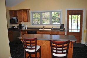 Well appointed kitchen with all the cookware, utensils, plates,.. Back door/deck