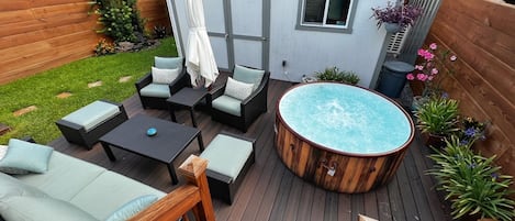 Shared backyard with spa and lounge furniture.
