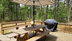 Deck looks out over wooded backyard
