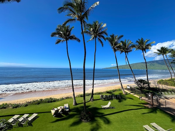 Private lanai overlooking the glittering Pacific and tropical grounds.