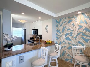 Enjoy serving your guests at the kitchen countertop with bar seating for two.