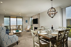 The dining and living areas of Coastal Cottage look down the beach to the Oceanside Pier.