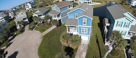 Front of Home with beautiful pond behind and water fountain.