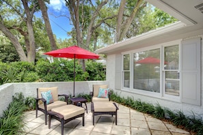 Front Patio • Lounge Chairs • Walk-to-Beach Location - Just off the front entry, this sunny patio with lounge chairs and a red umbrella is perfect for unwinding before dinner or catching a morning breeze. It’s the kind of space that feels tucked away but still steps from everything on Ocean Blvd.