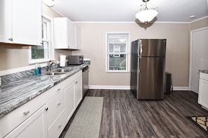 Cooking in a spacious space featuring SS appliance and Granite countertops.