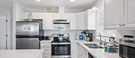 This gorgeous kitchen provides a comfortable space for you to prepare your meals