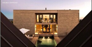 Sunset view of house and pool from Double Diamond