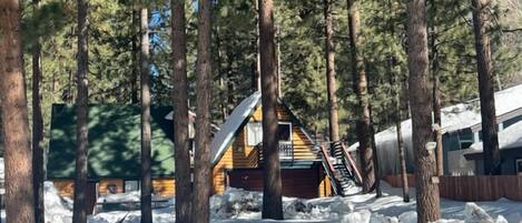 Snow covered Big Bear Cool Cabins, Log Cabin Retreat front