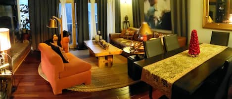 Living room has a warm vibe, comfy seating, and a wood burning fireplace.