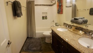 Guest en suite bath with soaking tub and double sinks. 