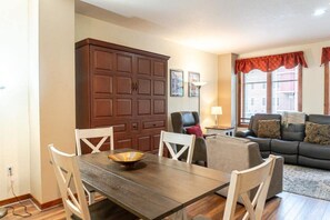 The dining table with its seats for four is an ideal bridge between the kitchen and living areas. Here you can see the Murphy bed, disguised as a large cabinet when not in use.