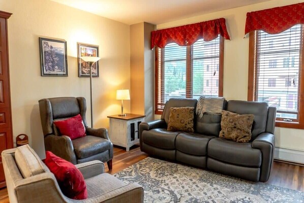 The cozy living room where you will find a pull out sofa, two armchairs, end tables, lamps, a flat-screen TV and a gas fireplace as well as access to a private balcony. A convenient Murphy bed also pulls out into a queen-size bed.