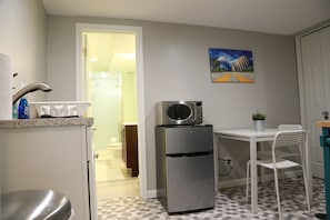 table, minifridge and microwave in kitchenette