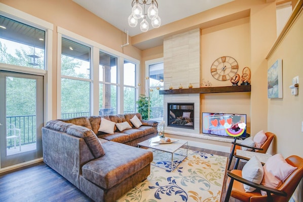 mountain view living room with balcony and patio
