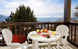 Some rooms have a balcony with a table