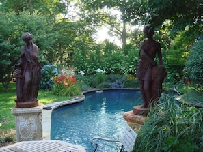 Heated salt water pool surrounded by beautiful english garden.