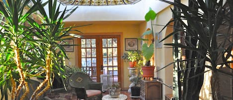 Solarium features 19th c. stained glass ceiling, french doors to porch