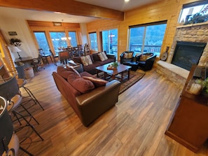 Living rm, dining 8+, bar/ bar stools, gas fireplace and door to upper deck