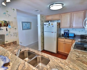 The modern kitchen has granite countertops, an icemaker and a new dishwasher.