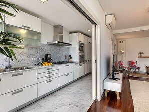 Modern fully equipped kitchen in an open style structure #coffeemachine #AC unit #smartTV