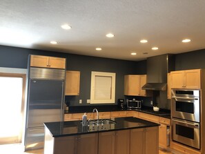 Kitchen with large refrigerator and double ovens 