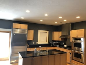 Kitchen with large refrigerator and double ovens