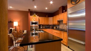 Gourmet kitchen with breakfast bar seating for 3