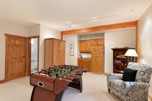 Foosball table and wet bar next to the media room