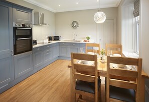 Ground floor: Fully equipped  kitchen with dining table and chairs seating four guests