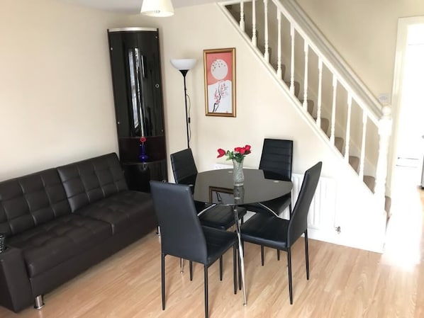 Living room with sofa bed, Table and chairs and TV