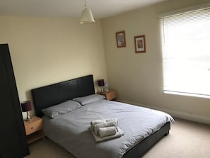 Main bedroom with double bed, wardrobe, dressing table and full length mirror.