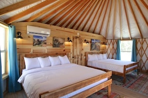 Yurt 9 has 2 king beds, a sofa bed, kitchenette, heaing and air conditioning with a private bathroom, tub and shower.