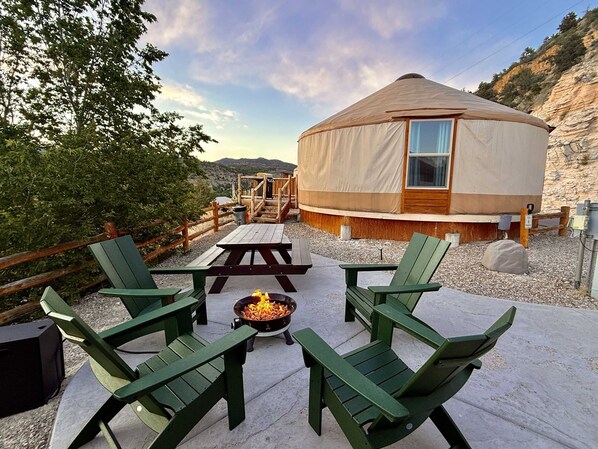 Yurt #6 nestled in the cliffs high above the valley at East Zion Resort.  Outdoor sitting area with gas fire pit, bbq grill & picnic table.  Perfect Glamping near Zion and Bryce Canyon
