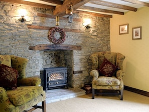 Living room with exposed stone and beamed ceiling | The Oak, Newchurch, near Hay-on-Wye