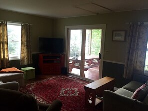 Family room that opens out to screened in porch.