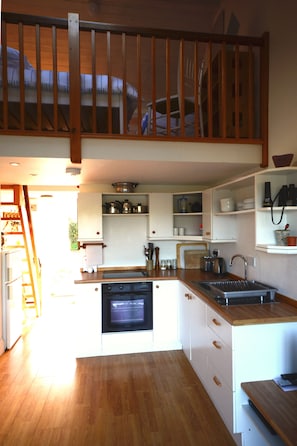 Open plan kitchen with mezzanine level above