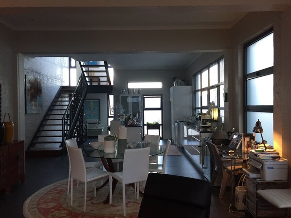 Open plan living room showing access to the roof terrace