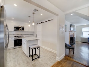 open floor plan with hardwood & tile throughout
