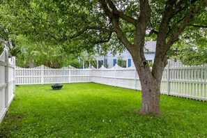 Large fenced yard with firepit