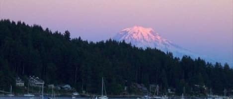 The moon and Mt. Rainier loom over Gig Harbor Bay