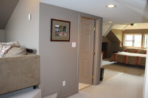 Private bathroom entry and peek into lounge area.